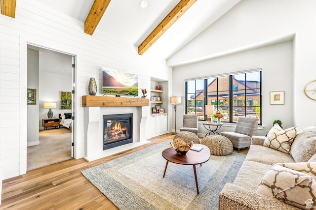 522 N Farmhouse Way, Midway, UT 84049 - living area featuring beam ceiling, light wood finished floors, a glass covered fireplace, built in shelves, and baseboards