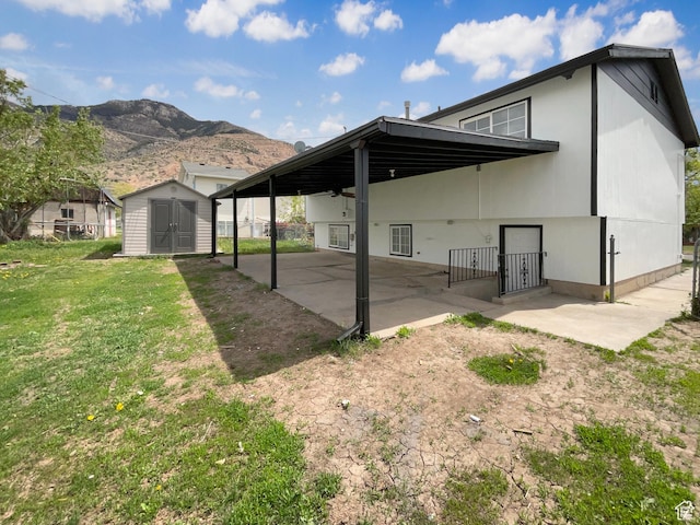 722 E 1300 N, Ogden, UT 84404 - rear view of house with a patio area, an outdoor structure, a mountain view, a shed, and a yard