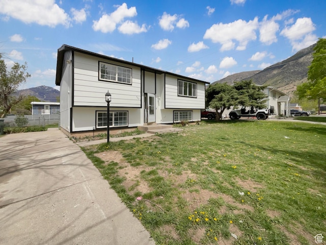 722 E 1300 N, Ogden, UT 84404 - raised ranch featuring fence, a mountain view, and a front lawn