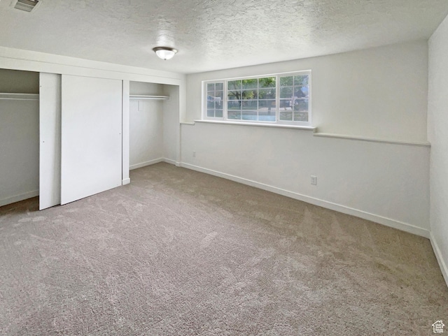 722 E 1300 N, Ogden, UT 84404 - unfurnished bedroom featuring carpet flooring, a textured ceiling, and baseboards