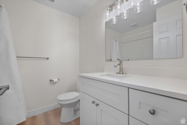 3841 E Grindstone Dr S, Springville, UT 84663 - full bathroom featuring visible vents, wood finished floors, vanity, baseboards, and toilet