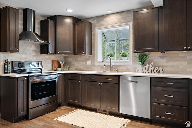 3841 E Grindstone Dr S, Springville, UT 84663 - kitchen featuring wall chimney range hood, appliances with stainless steel finishes, a sink, and dark brown cabinets