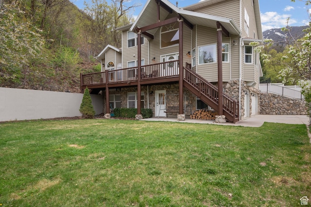 3841 E Grindstone Dr S, Springville, UT 84663 - back of property featuring a wooden deck, concrete driveway, a yard, and stone siding