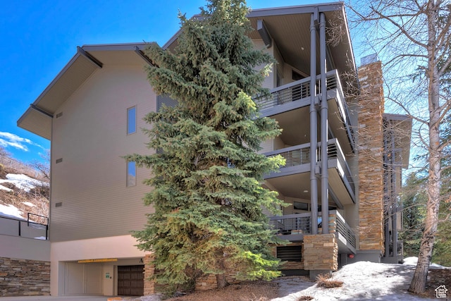 exterior space featuring a balcony and stucco siding