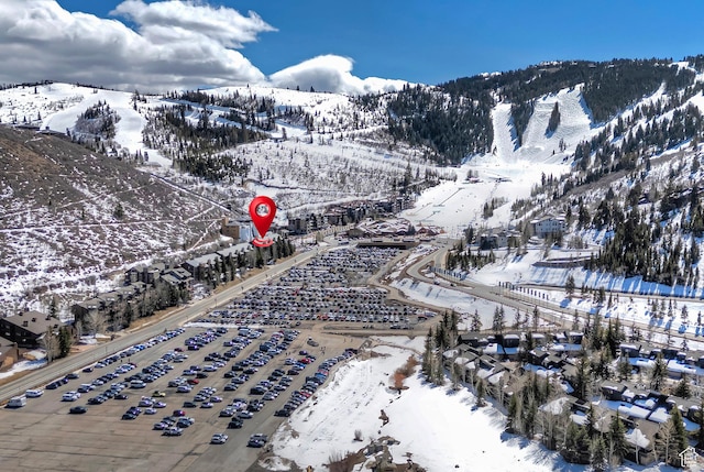 snowy aerial view featuring a mountain view