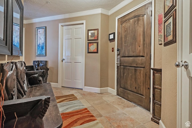 foyer entrance featuring a textured ceiling and baseboards