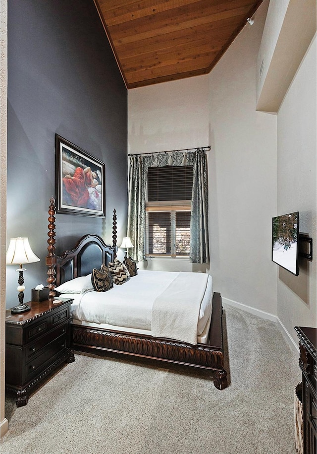 carpeted bedroom featuring baseboards and wooden ceiling