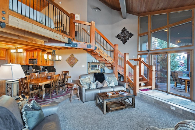 living room featuring carpet, a towering ceiling, and stairway