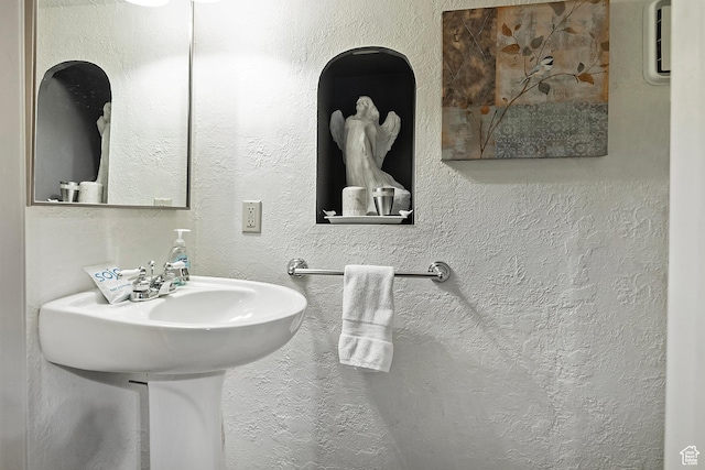 bathroom with a textured wall
