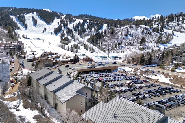 snowy aerial view with a mountain view