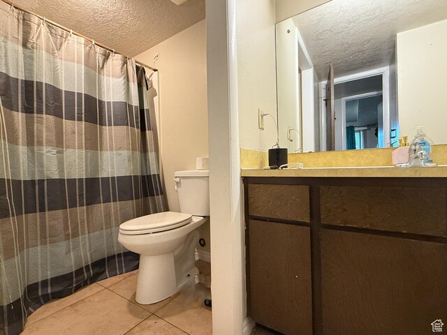 1357 S Lorl Ln # 2, Ogden, UT 84404 - full bathroom featuring vanity, tile patterned flooring, toilet, and a textured ceiling