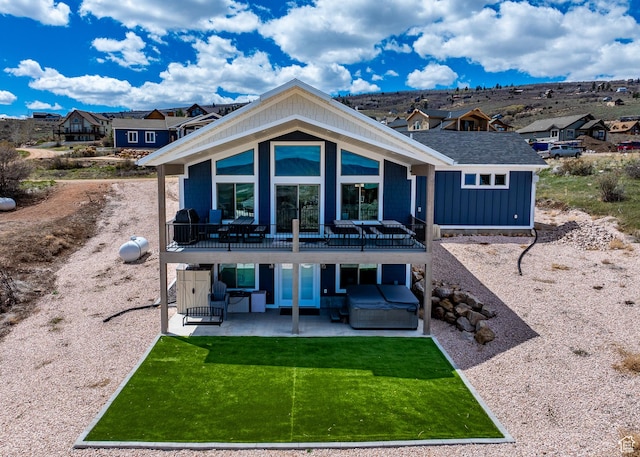 2774 S Chukar Dr, Garden City, UT 84028 - rear view of property with a deck, a patio area, a lawn, a hot tub, and a residential view