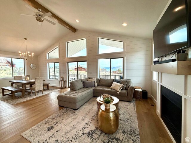 2774 S Chukar Dr, Garden City, UT 84028 - living room featuring wood finished floors, a fireplace, beamed ceiling, baseboards, and high vaulted ceiling