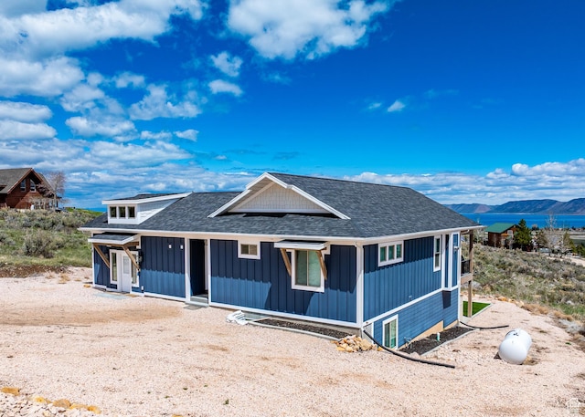 2774 S Chukar Dr, Garden City, UT 84028 - view of front of home with board and batten siding, roof with shingles, and a mountain view