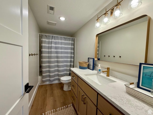 2774 S Chukar Dr, Garden City, UT 84028 - full bath featuring visible vents, wood finished floors, vanity, toilet, and shower / tub combo with curtain