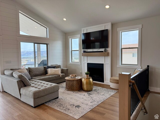 2774 S Chukar Dr, Garden City, UT 84028 - living area featuring a fireplace, recessed lighting, vaulted ceiling, and light wood-type flooring