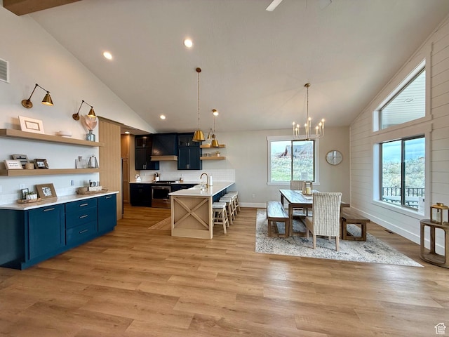 2774 S Chukar Dr, Garden City, UT 84028 - dining area featuring high vaulted ceiling, light wood-type flooring, and a notable chandelier