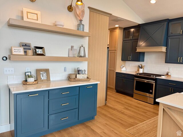 2774 S Chukar Dr, Garden City, UT 84028 - interior space featuring decorative backsplash, light wood finished floors, stainless steel gas stove, and visible vents