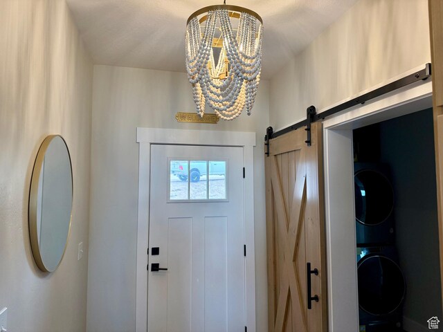2774 S Chukar Dr, Garden City, UT 84028 - interior space featuring stacked washer / drying machine, a notable chandelier, and a barn door