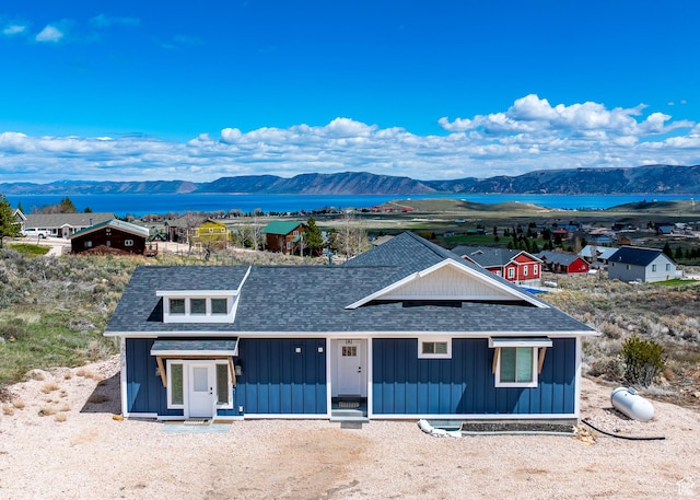 2774 S Chukar Dr, Garden City, UT 84028 - view of front of house with a shingled roof, board and batten siding, and a water and mountain view