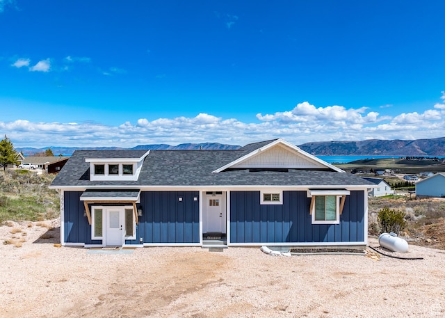 2774 S Chukar Dr, Garden City, UT 84028 - view of front facade with board and batten siding, a mountain view, and roof with shingles