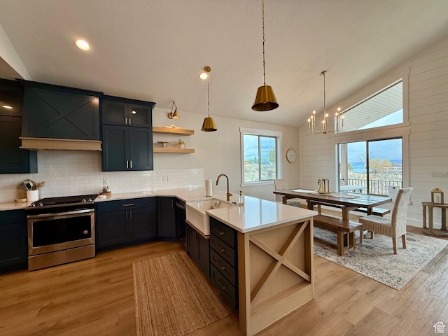 2774 S Chukar Dr, Garden City, UT 84028 - kitchen with open shelves, a sink, stainless steel gas range oven, light countertops, and a peninsula