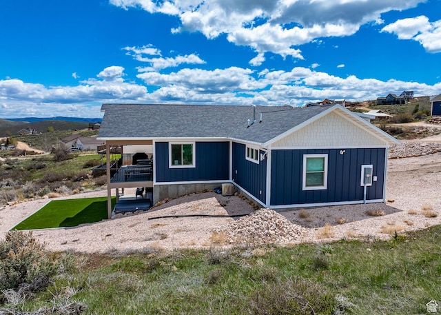 2774 S Chukar Dr, Garden City, UT 84028 - view of front of home featuring a shingled roof and board and batten siding