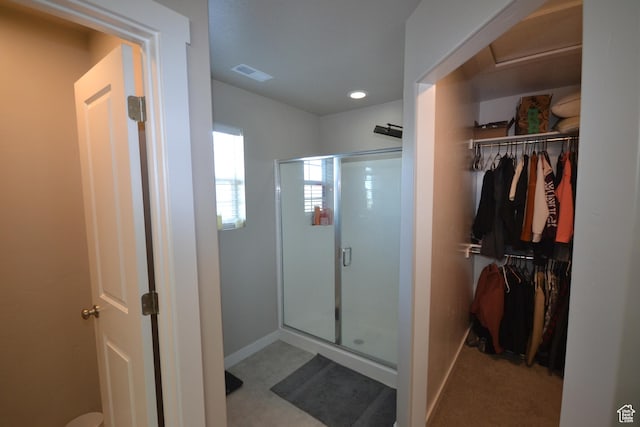 5745 N Gray Hawk Dr, Stansbury Park, UT 84074 - bathroom featuring a stall shower, a walk in closet, baseboards, and recessed lighting