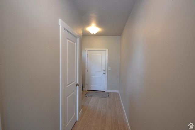 5745 N Gray Hawk Dr, Stansbury Park, UT 84074 - hallway featuring baseboards and light wood-style floors