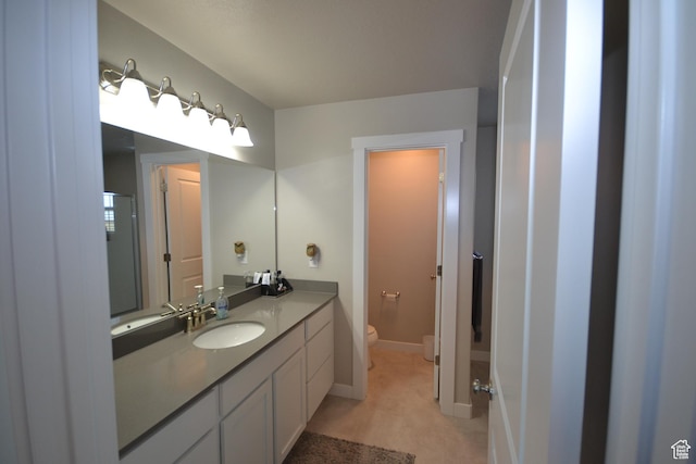 5745 N Gray Hawk Dr, Stansbury Park, UT 84074 - bathroom with toilet, vanity, and baseboards