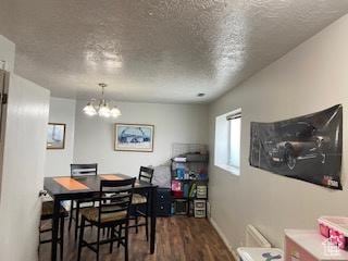 2622 N 175 W, Sunset, UT 84015 - dining space with a textured ceiling, wood finished floors, a chandelier, and baseboards