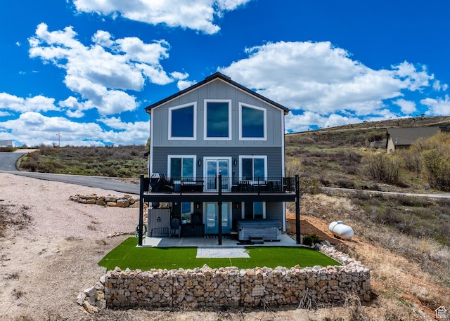 660 N Cambry Dr, Garden City, UT 84028 - back of property with a wooden deck, board and batten siding, a patio area, french doors, and a lawn