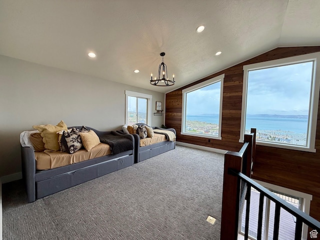 660 N Cambry Dr, Garden City, UT 84028 - interior space featuring an inviting chandelier, carpet, vaulted ceiling, and wooden walls