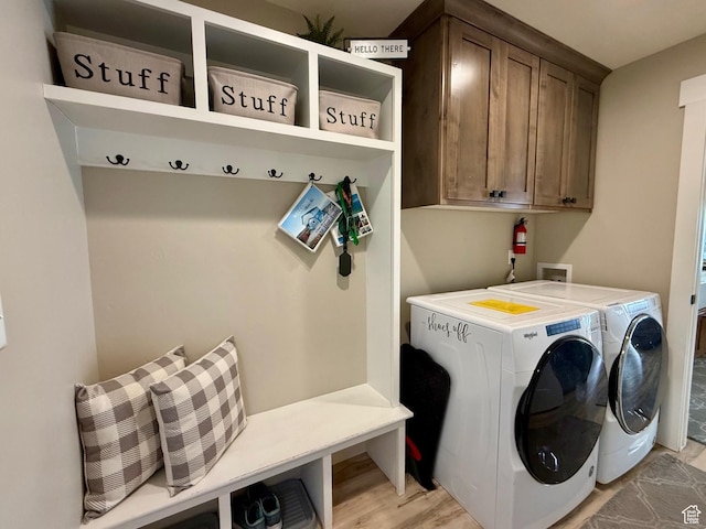 660 N Cambry Dr, Garden City, UT 84028 - washroom with light wood-style flooring, cabinet space, and washing machine and clothes dryer