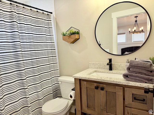 660 N Cambry Dr, Garden City, UT 84028 - full bathroom with an inviting chandelier, vanity, toilet, and curtained shower