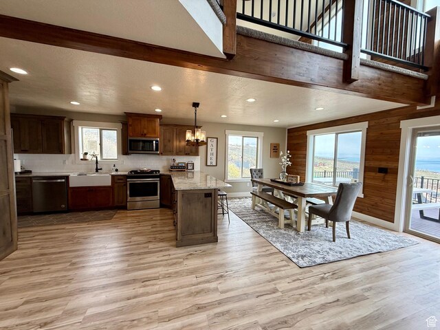 660 N Cambry Dr, Garden City, UT 84028 - kitchen featuring appliances with stainless steel finishes, a sink, light wood finished floors, a notable chandelier, and recessed lighting