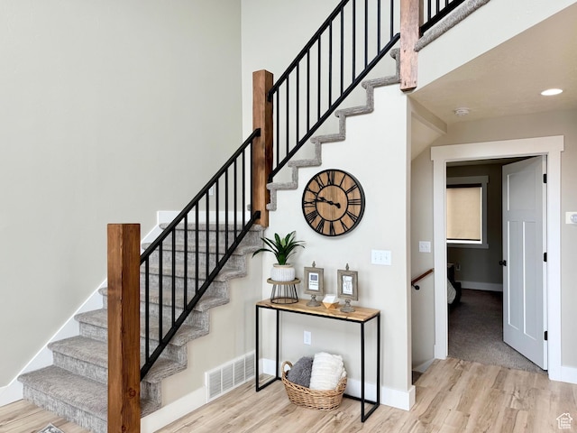 660 N Cambry Dr, Garden City, UT 84028 - stairway with visible vents, a high ceiling, baseboards, and wood finished floors