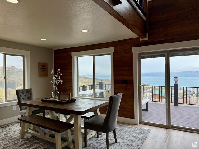 660 N Cambry Dr, Garden City, UT 84028 - dining area featuring light wood-style floors, recessed lighting, a water view, and wooden walls