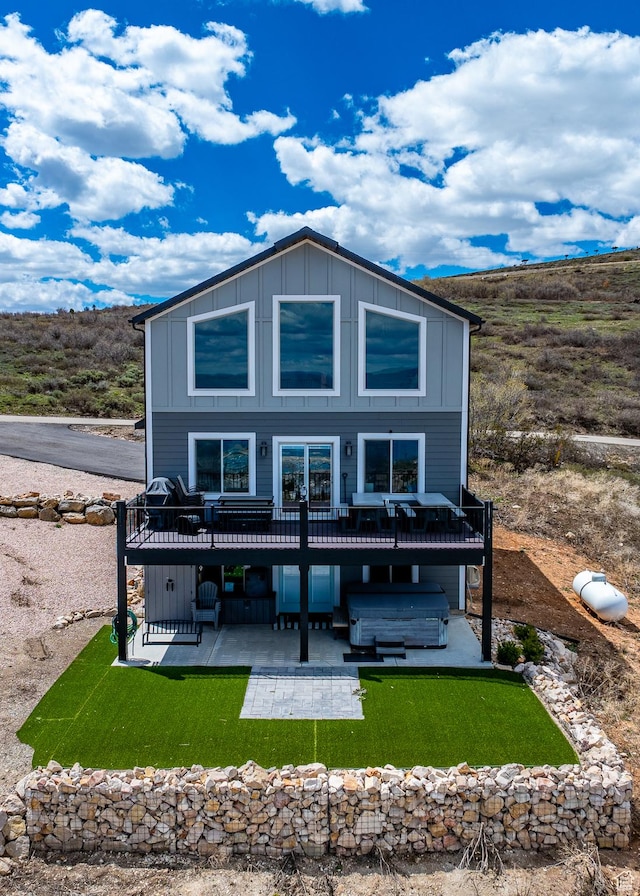 660 N Cambry Dr, Garden City, UT 84028 - back of house featuring board and batten siding, a patio, a wooden deck, and a jacuzzi