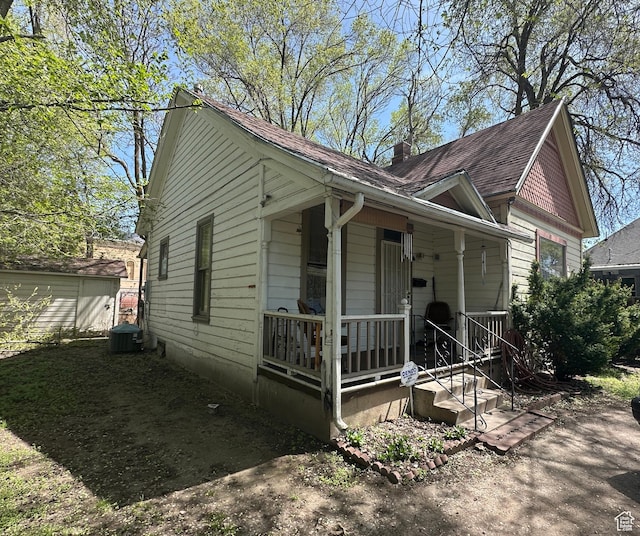 658 23rd St Unit 1, Ogden, UT 84401 - bungalow with a porch, roof with shingles, central air condition unit, and a chimney