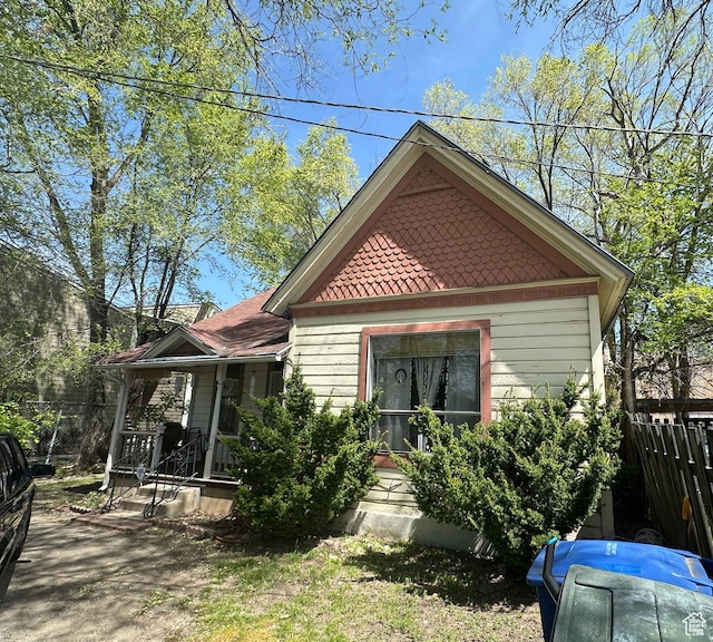 exterior space with fence and covered porch