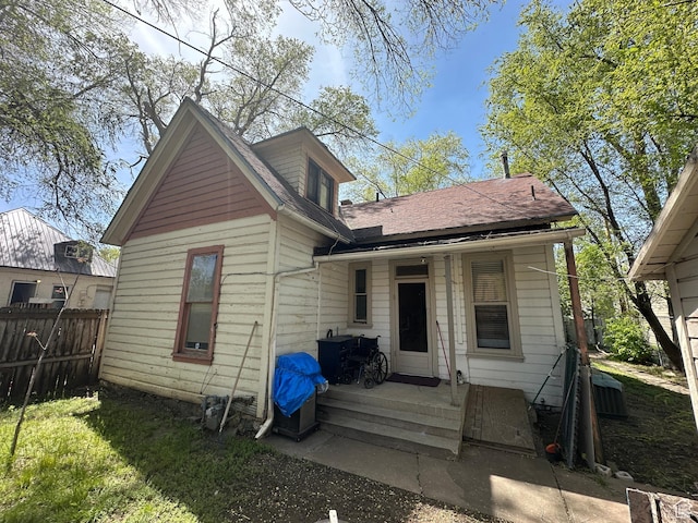 658 23rd St Unit 1, Ogden, UT 84401 - rear view of property featuring a shingled roof and fence
