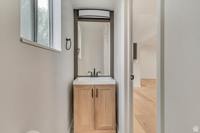 4238 W Old Miller Ct S, Salt Lake City, UT 84118 - bathroom featuring vanity, baseboards, and wood finished floors