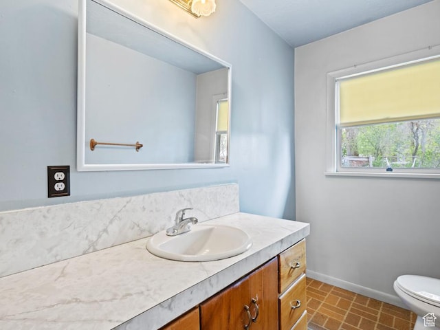 1417 E Binford St, Ogden, UT 84401 - half bath featuring toilet, baseboards, brick patterned floor, and vanity