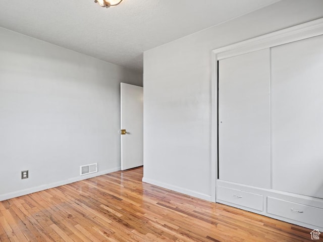 1417 E Binford St, Ogden, UT 84401 - unfurnished bedroom featuring wood-type flooring, baseboards, visible vents, and a closet