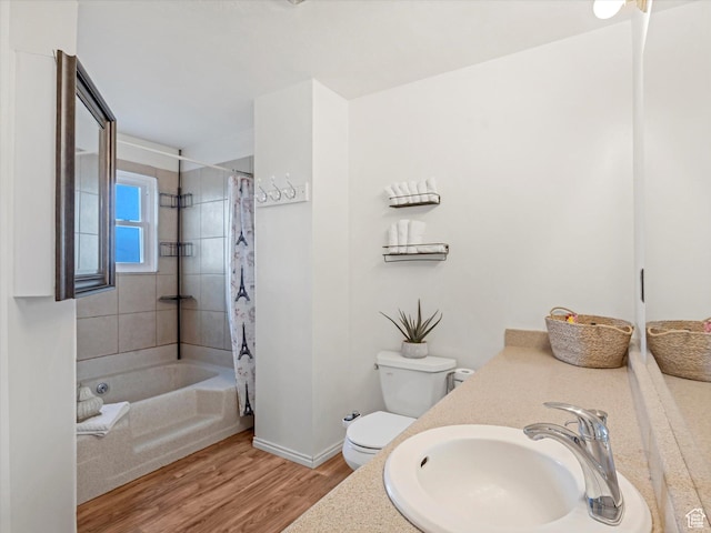 bathroom featuring vanity, wood finished floors, shower / bath combination with curtain, toilet, and baseboards