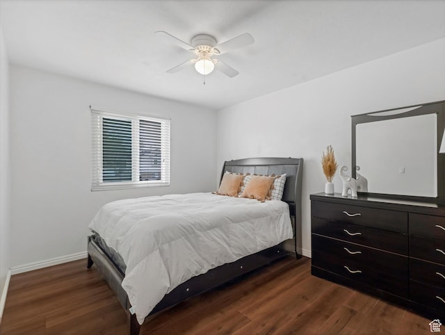 bedroom featuring dark wood-type flooring, baseboards, and ceiling fan