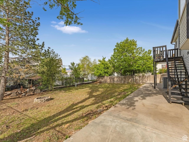 view of yard with stairs, a patio area, and fence