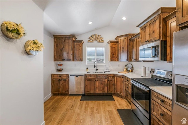 591 S Lakeside Dr, Franklin, ID 83237 - kitchen with appliances with stainless steel finishes, a sink, vaulted ceiling, and light wood-style floors