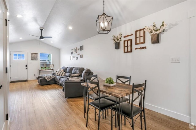 591 S Lakeside Dr, Franklin, ID 83237 - dining area with lofted ceiling, baseboards, recessed lighting, light wood-style flooring, and ceiling fan with notable chandelier